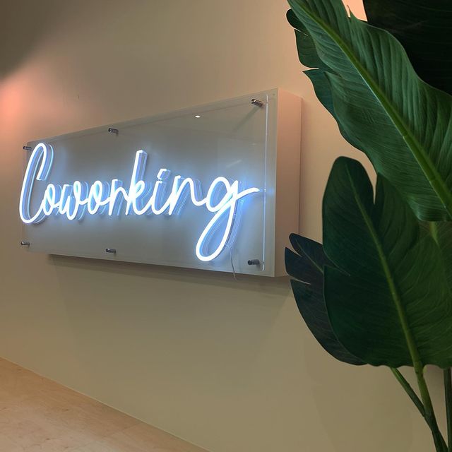 white neon sign that says &quot;Coworking&quot;