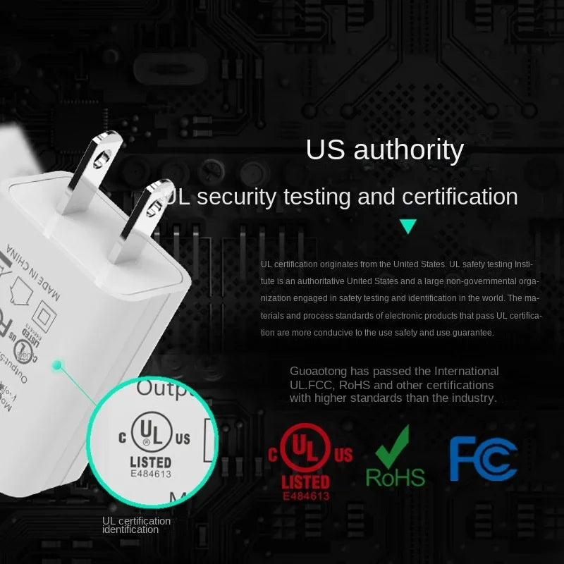 Close-up of certification markings on white USB-A wall charger