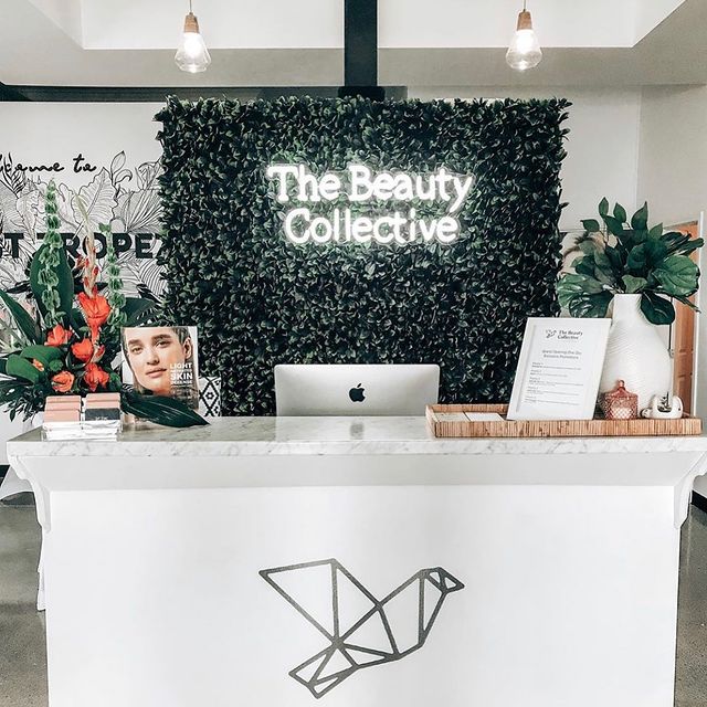 white neon sign that says &quot;The Beauty Collective&quot;